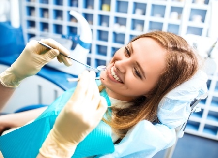 Woman smiling during a dental checkup