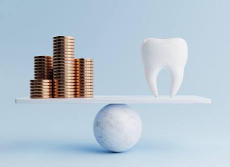 Coins balanced against tooth