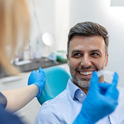 Male patient seeing dentist about Invisalign aligners