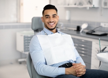 Smiling man sitting in dental chair