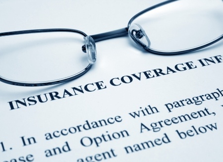 Reading glasses resting on dental insurance form