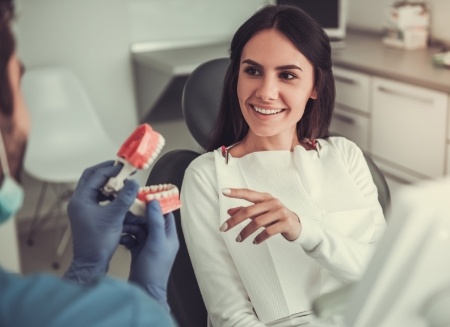 Dentist showing dentures to a patient