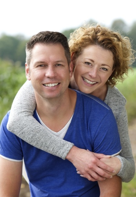 Man and woman smiling outdoors