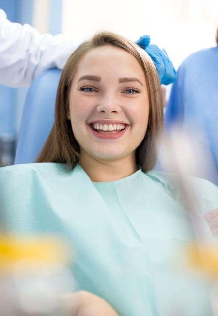 Young woman grinning in dental chair in Sachse