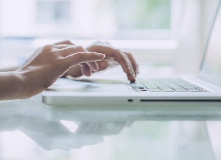 Person typing on laptop