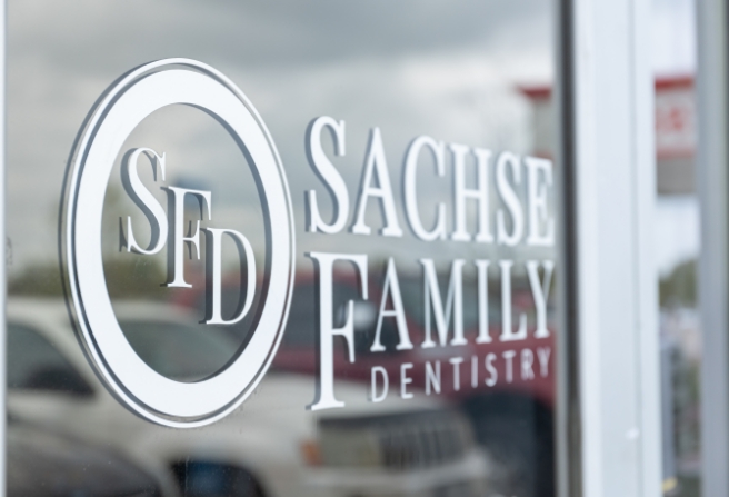 Sachse Family Dentistry at Woodbridge sign on outside of door