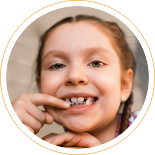 Young girl pointing to braces on her lower teeth