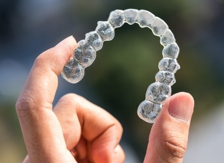 Closeup of Invisalign on colorful outdoors background