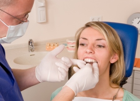 Dentist fitting a patient with an Invisalign aligner