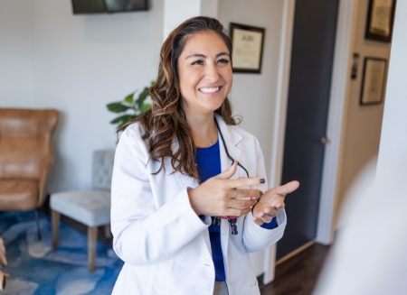 Herrera smiling and talking to patient