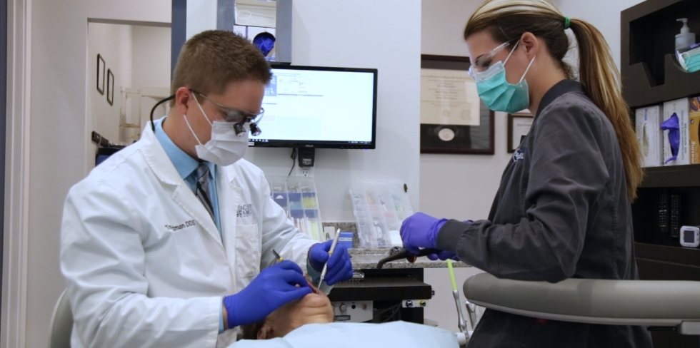 Doctor Rottman and dental assistant treating a patient