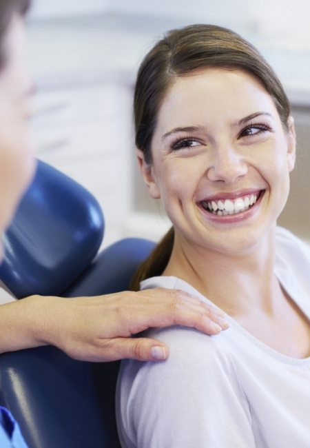 Woman smiling at Sachse dental team member