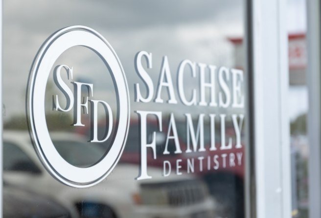 Sachse Family Dentistry at Woodbridge logo on glass door