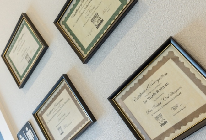 Several framed diplomas and certificates for Doctor Travis Rottman