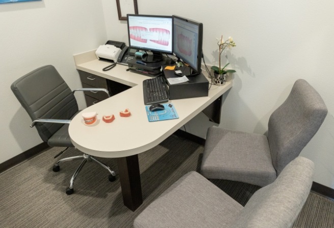 Consultation desk with computer showing digital models of teeth