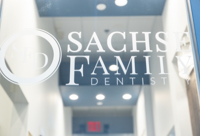 Sachse Family Dentistry at Woodbridge logo on glass door