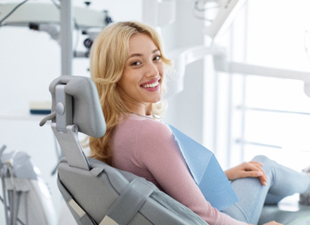 Woman smiling while sitting in treatment chair