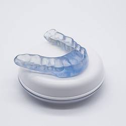 Occlusal splint sitting on top of its storage case