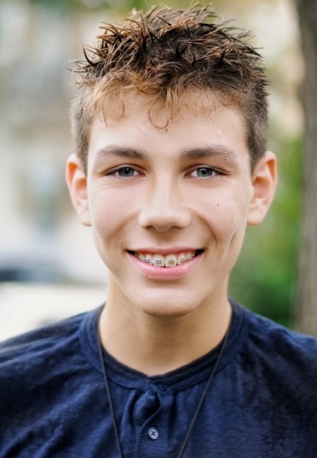 Teenage boy smiling with traditional braces in Sachse