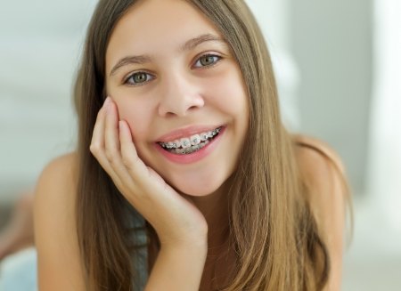 Teenage girl smiling with traditional braces