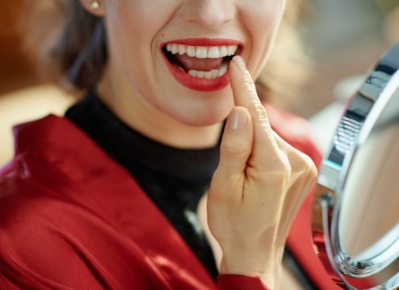 Woman looking at her smile in mirror