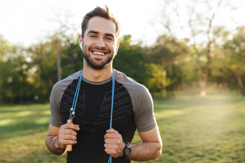 A fit man engaged in exercise and smiling with good teeth