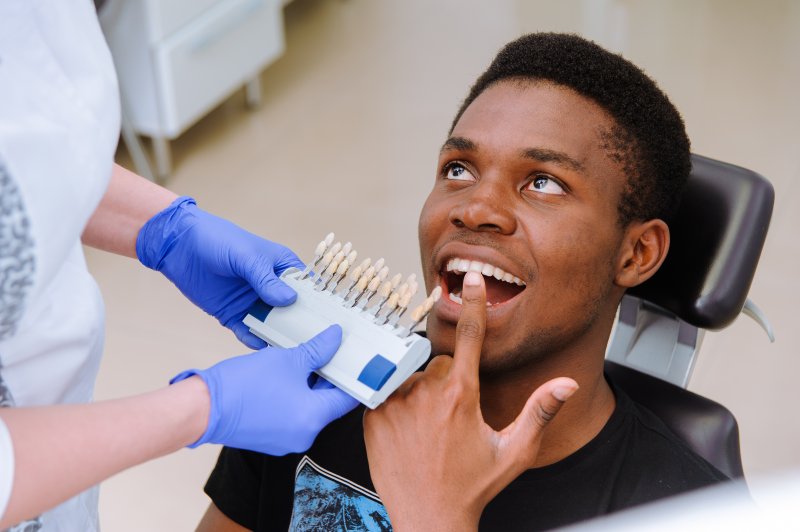 A cosmetic dentist in Sachse assessing a patient