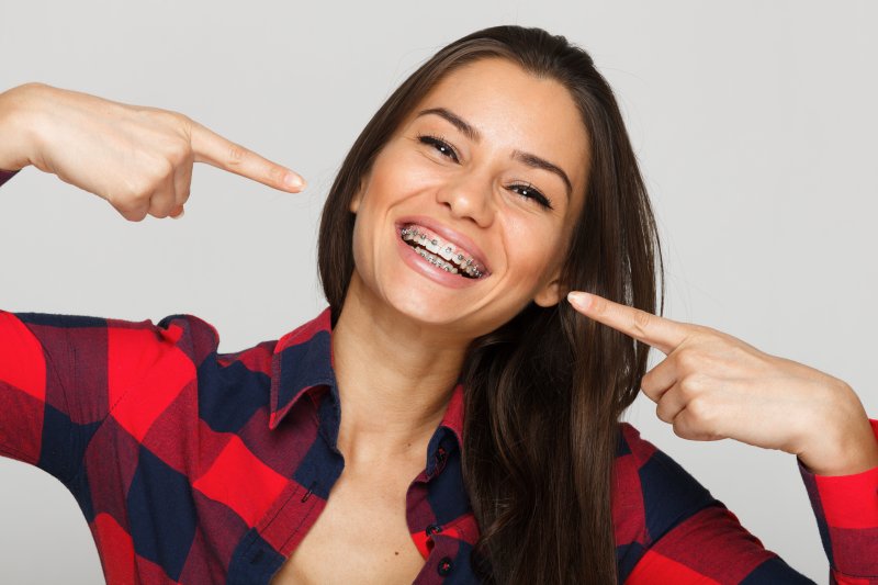 Young woman smiling with braces