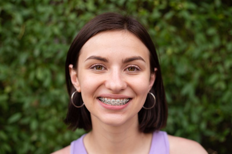 Smiling person wearing braces