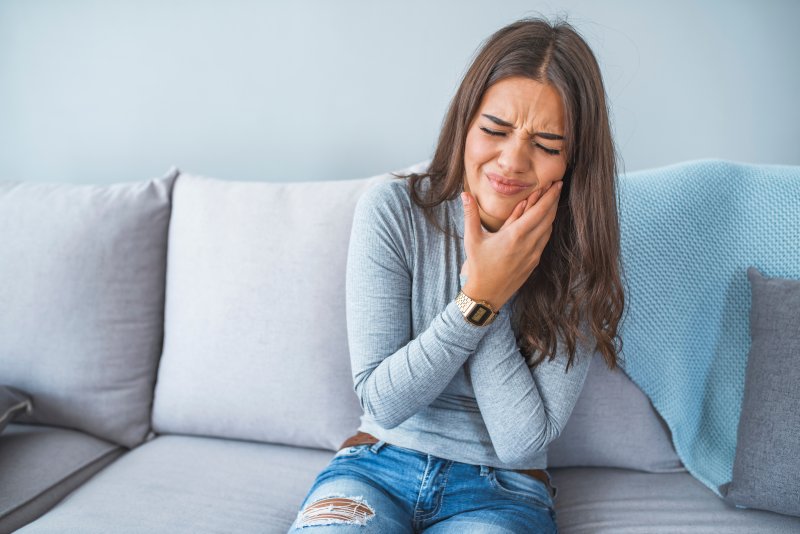 A woman suffering from some kind of oral pain