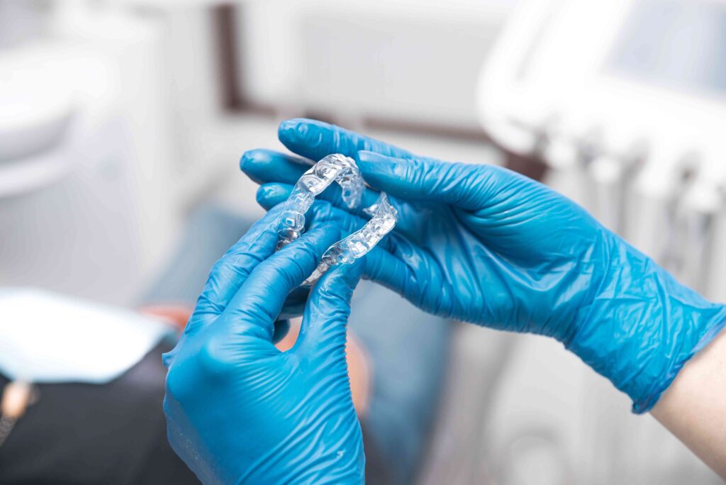 Dentist holding aligners