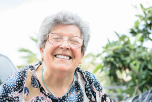 Woman smiling while sitting outdoors